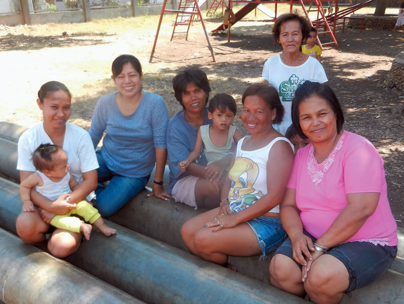 Columban Lay Missionary Ana Flores Huanam and villagers